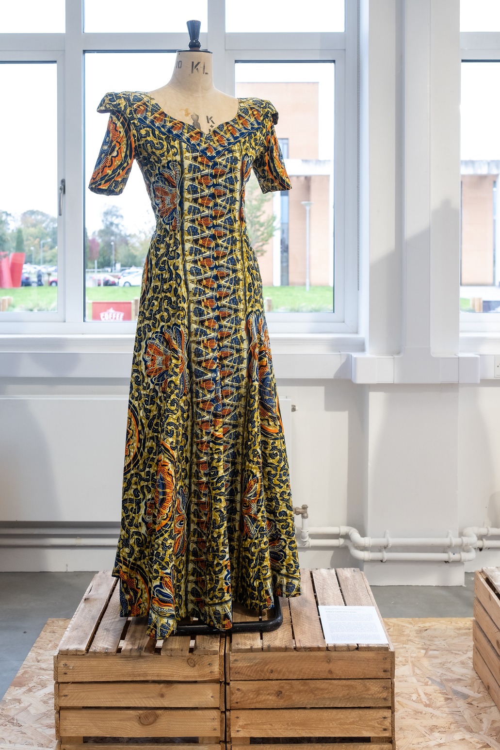 Nigerian party dress in varied bold colours on a mannequin